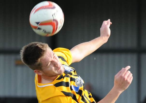 Worksop Town FC Maltby Main.  
Max Pemberton gets head and shoulder above Jonathan Hill.