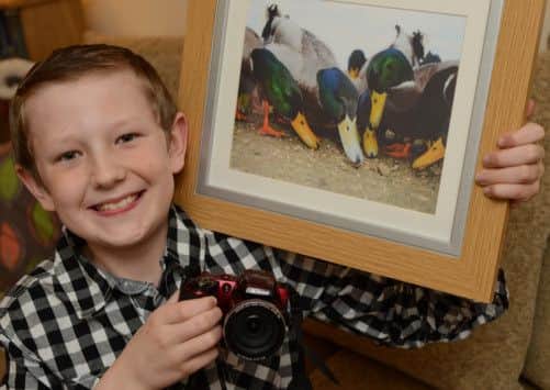 James Ashton, nine has won the under 10's section of a National Trust photo competition titled Your Space. James won with his picture of ducks taken at Clumber Park (w130109-1b)