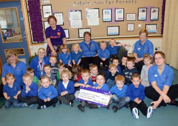 Dinnington Children's Centre present a cheque for £236.00 to Bluebell Wood Children's Hospice w130115-2