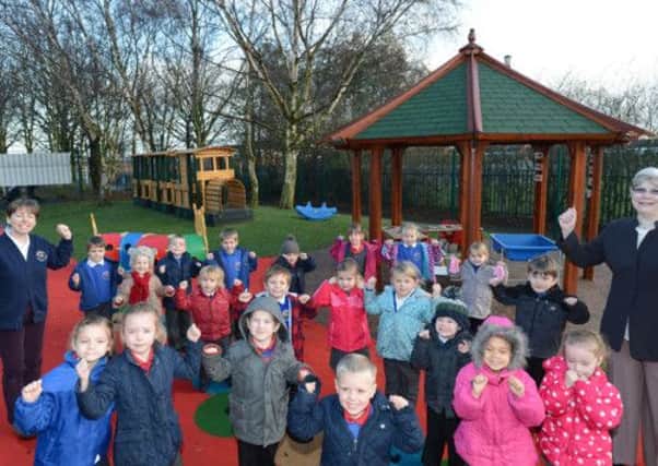 Pupils and staff at Prospect Hill Infant School celebtrate the opening of the new playground.  Pictured with pupils is nursery teacher Julia Morris and chairman of governors Janet Pimperton.