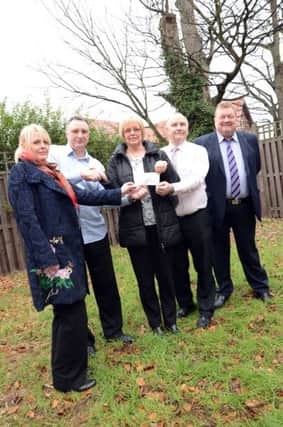 Eaton Production present a cheque for £12,500 to NORSACA for a sensory garden at Tall Trees Day Services in Retford w130208-3b