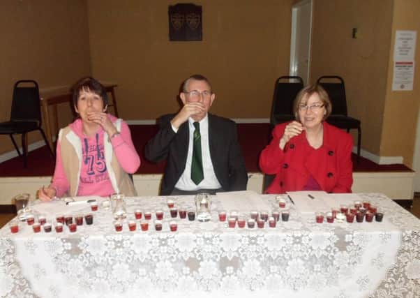 Sloe gin judges Maxine Seeley, Peter Bainbridge and Coun Sybil Feilding taste entries at the 2013 Shireoaks Sloe Gin Competition