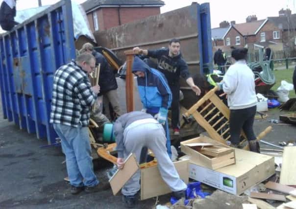 The Maltby Safer Neighbourhood Team joined forces with Rotherham Council, South Yorkshire Fire and Rescue and residents for a day of action. Pictured are residents filling a skip with litter and waste