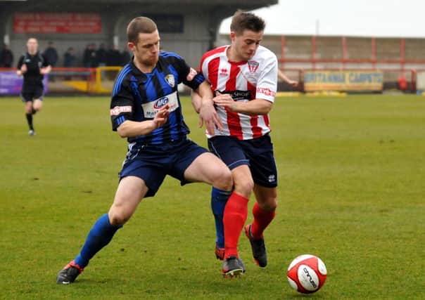 Ryan Clarke puts in a tackle at Witton