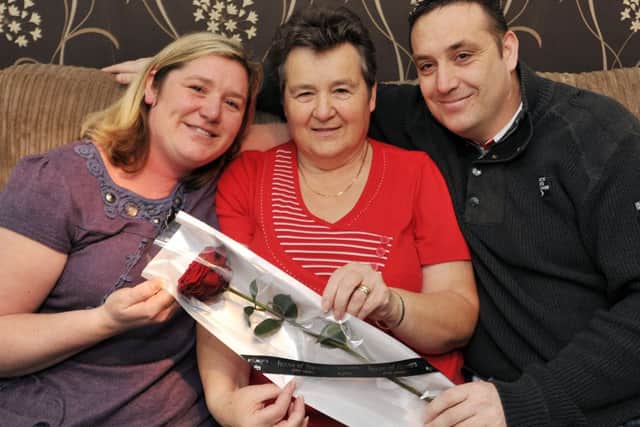 Guardian Rose presentation to Joan Carroll from her children, Steven and Sonia.
Pictured is Joan, centre with Sonia and Steven (w130318-4a)
