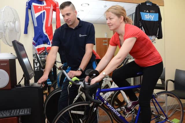 Andy Bishop from Apple Gym in Worksop and reporter Helen Johnston with a new cycling training bike G130322-5f