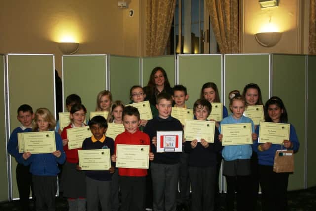 Coun Rebecca Leigh with pupils holding their certificates. Pictured centre is logo competition winner Niall Cartwright Goy holding his design.