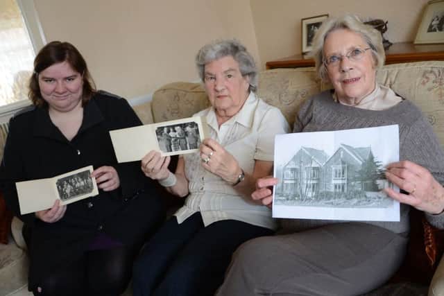 Lauren Astburly, Jean Drabble and Dorothy Sykes with some old photographs of the Maltby Urban District Council G130419-2b