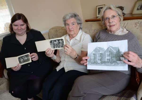 Lauren Astburly, Jean Drabble and Dorothy Sykes with some old photographs of the Maltby Urban District Council G130419-2b