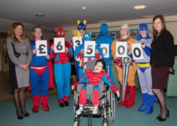 Staff from HSBC dressed as superheroes for children at Bluebell Wood Children's Hospice
