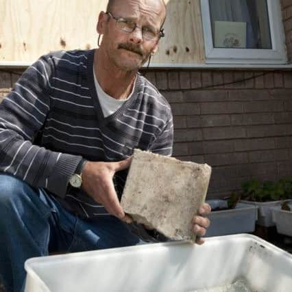 Jim Bradford with the lump of rock used by thieves who broke into his Sandy Lane home on Tuesday