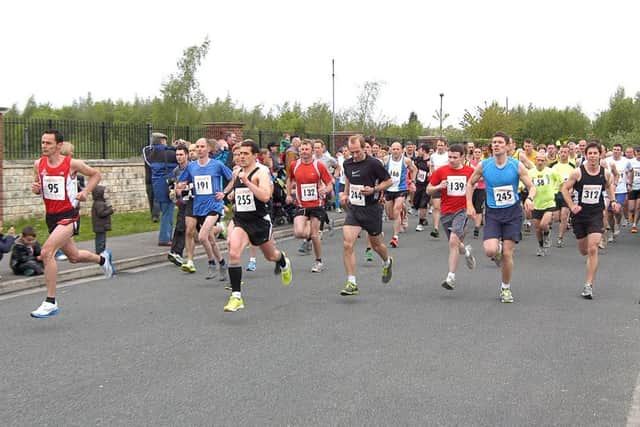 Worksop Guardian Towpath and Trail 10km race and fun run organised by Clowne Road Runners, runners leaving the start (w120521-11a)