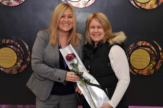 Guardian Rose presentation to Outwood Academy Valley Year 11 Learning Manager Stacey Anderson-Gilling, Stacey is pictured recieving her rose from Angela Templeton who nominated her for helping her Son Matthew reach his potential (w130523-1a)