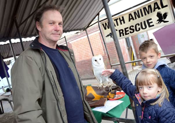 Birds of Prey from Wath Animal Sanctuary visited Dinnington Market on Saturday. Pictured are Ian Stacey, Ollie Thompson, six, and Jasmine Thompson, five G130518-6