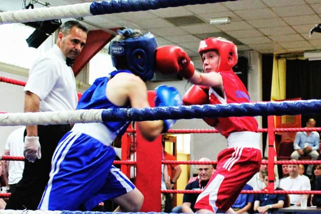Marcus Ellis boxing, in red