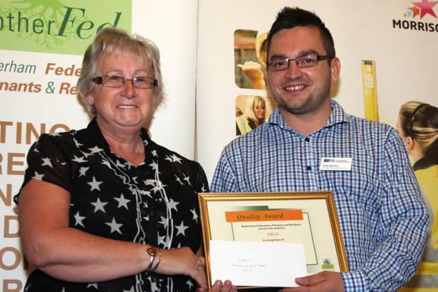 Wendy Wood of Kiveton Bungalow Users Group (KBUG) receives a gold award at the Rother Fed Quality Awards from Andy Boulton from South Yorkshire Housing