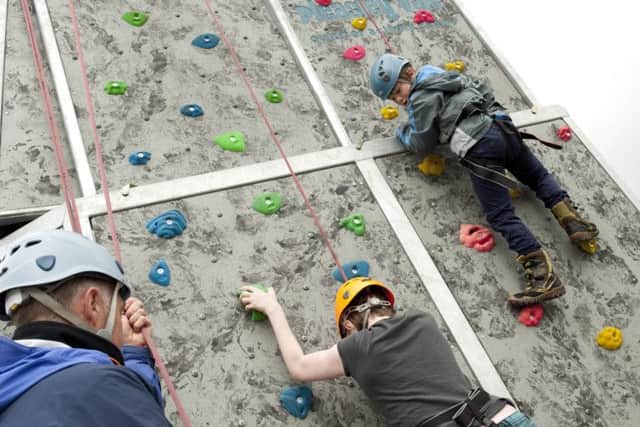 Luca Sinclair tackles the climbing wall at Clowne family fun day