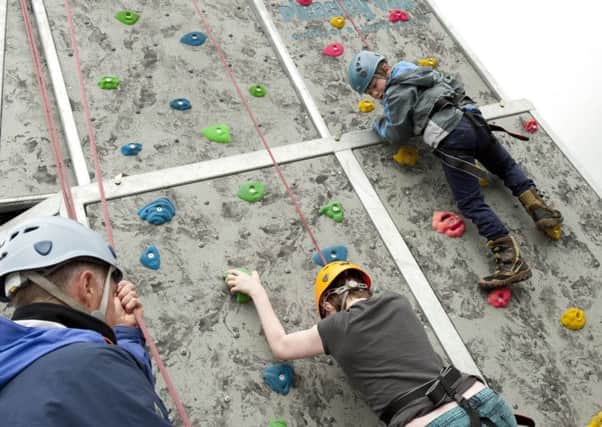 Luca Sinclair tackles the climbing wall at Clowne family fun day