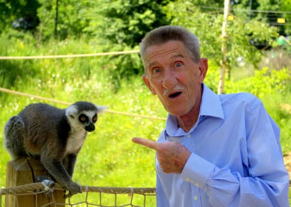 Barry Elliott with a Ring-tailed Lemur at the Tropical Butterfly House, Wildlife and Falconry Centre, photograph by Ben Coulson