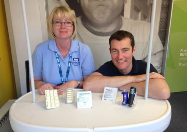 Lindsey Askwith, stop smoking advisor and Simon Lister, manager of the Rotherham NHS Stop Smoking Service, showing the NRT products available when clients join the stop smoking programme