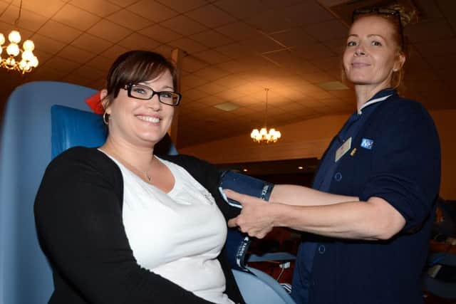 Karen Currie giving blood at the Weston Rooms in Gainsborough G130731-3a