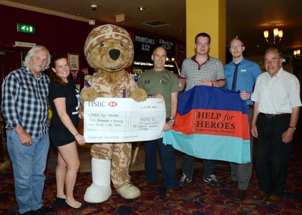 Wetherspoons staff at The Liqourice Gardens in Worksop present a cheque to Tony Eaton from Help for Heroes G130712-4