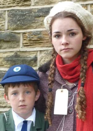 Evacuees Carrie (Juliet Ibberson) and her brother Nick (Thomas Ferris) anxiously wait to see if someone will give them a home