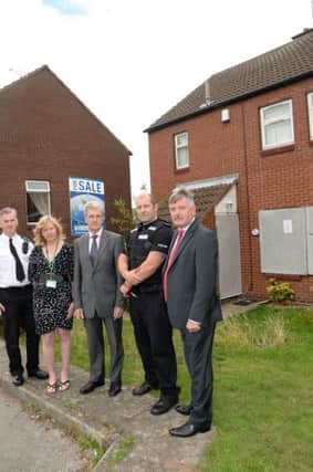 Boarded up crack house on Carnoustie in Worksop. Pictured are Chief Inspector Paul Murphy, Tammy Haywood, Coun Griff Wynne, Sgt Mark Goddard and Coun Glynn Gilfoyle G130810-2b