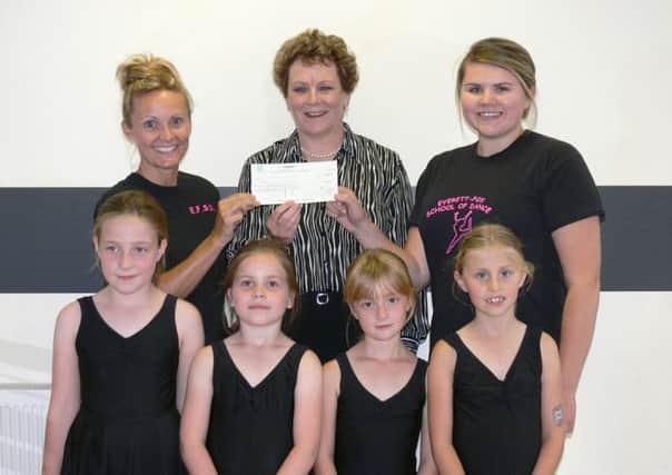 District Coun Hazel Brand is pictured presenting a cheque for £200 to EFSD owner, Tracey Everett-Fox (left) and assistant, Lauren Riley, with pupils of one of the childrens dance classes.