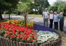 Vaughan Hughes and Anna Grieve from Gainsborough In Bloom, admire the planter outside the former Guildhall with West Lindsey District Councillors Richy Doran and Gillian Bardsley.