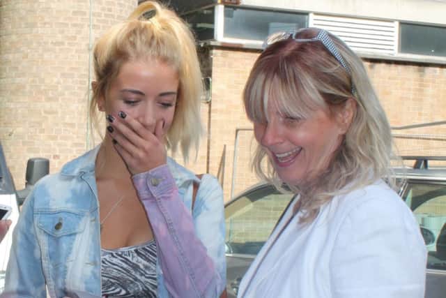 Jennifer Reid with her mum Heather opening her GCSE results envelope