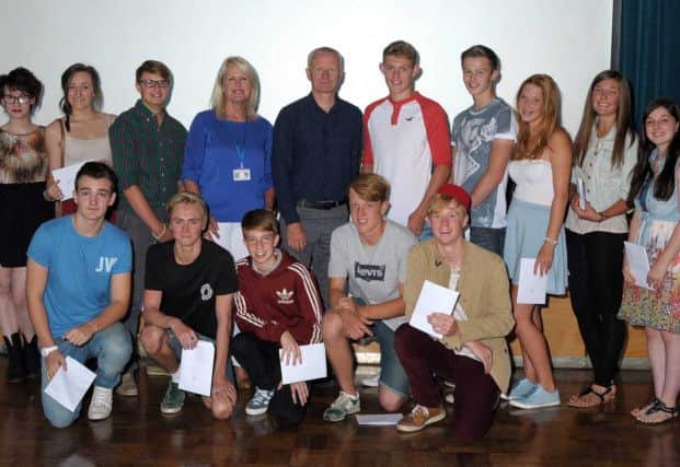 GCSE results day at Dinnington Comprehensive, pictured are students with headteacher Paul Blackwell and chair of govenors Monica Carroll (w130822-3e)