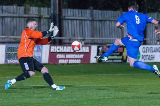Graeme Armstrong tucks the ball past Worksop keeper Ben Hallam for Whitby's opening goal
picture: Brian Murfield