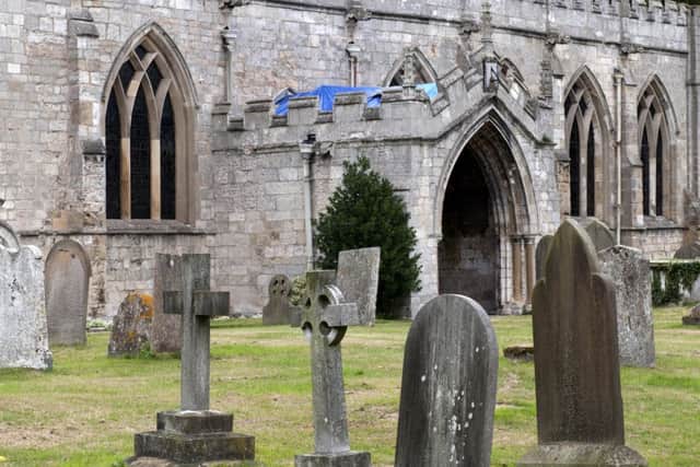Blue tarpaulin covers the porch roof of St Mary and St Martin Church, Blyth, were thieves had stripped the roof of lead.