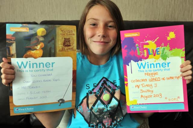 Maggie Anne Grant, 10 collected enough bottletops while on holiday in Turkey to supply a wheelchair for a disabled child, Maggie Anne is pictured with her certificates