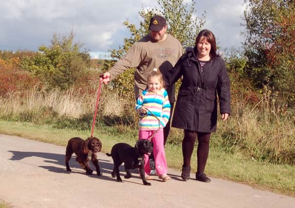 Bark around the Park sponsored walk in aid of Bluebell Wood Children's Hospice, pictured are Maisie Bonewell, five with Auntie and Uncle Marie and Andrew Phillips and dogs Joe and Madge (w121015-4c)