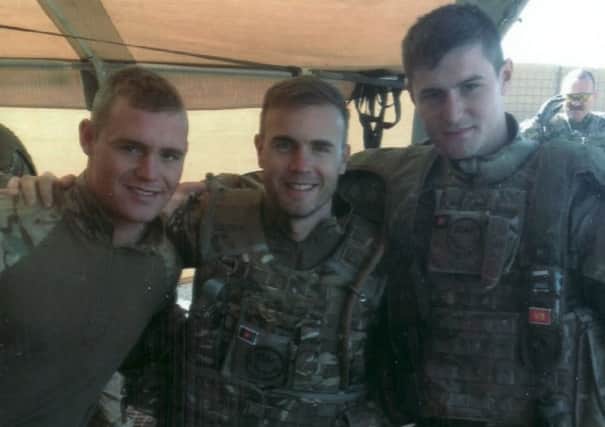 Whitwell soldier Daniel O'Keefe (left) with friend Mitchell Parker and Take That star Gary Barlow