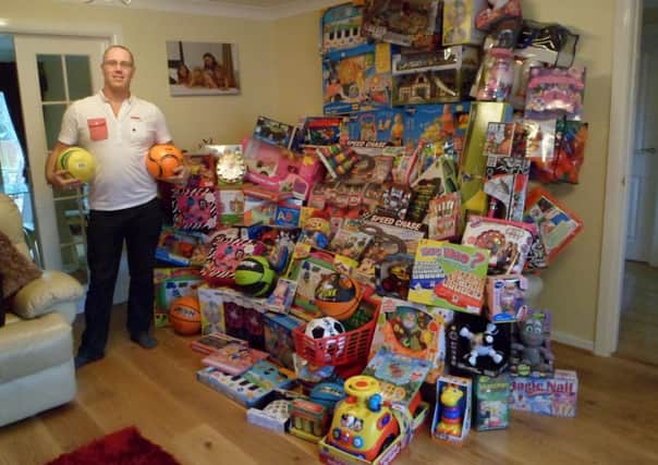 Paul Tomkins of PMT Engineering Services Limited with the toys that will be donated to Bluebell Wood Children's Hopsice