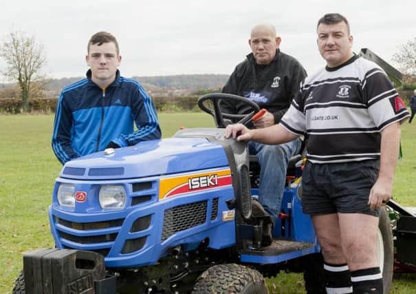 Alan Hopkinson of Worksop Rugby Union FC and groundsman James Waddell and assistant Reece Waddell with the clubs new tractor funded by a n RFU grant.
