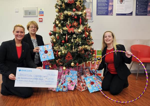 H & T Pawnbrokers have been busy fundraising to buy presents for Bassetlaw Hospitals Children's Ward, pictured from left are deputy manager Jade Stapels, manager Andrea Bell and sales assistant Leanne White (w131214-1a)