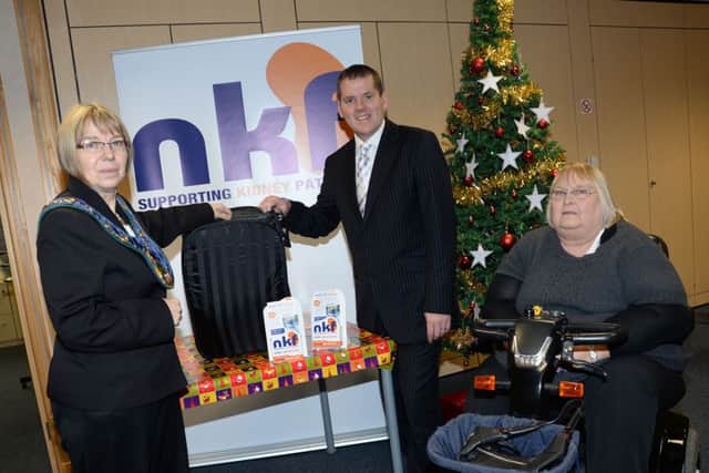 The Chairman of Bassetlaw District Council Sybil Fielding draws the winning tickets for the National Kidney Federation's grand draw. Also pictured are Head of Fundraising Peter Revell and Denny Abbott G131213-5a