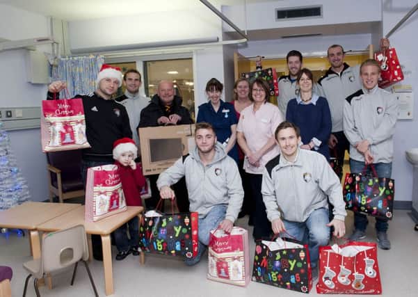 Players and staff from Worksop Town visited the Bassetlaw Hospital Childrens Ward to hand out Christmas presents and a new television for the ward