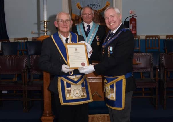 Cyril Morris receives his certificate marking 50 years as a Freemason from Assitant Provincial Grand Master Philip Marshall