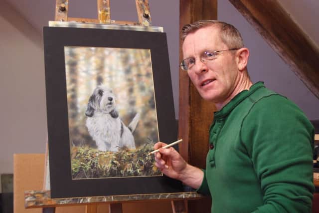Artist Paul Doyle with his portrait of Jilly