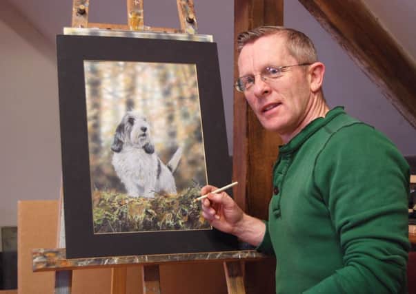Artist Paul  Doyle with his portrait of Jilly