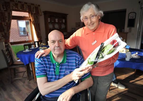Guardian Rose presentation to Betty Barrowcliffe, Betty is pictured receiving her rose from Westwood Residential Home resident Ronald Crookes (NWGU-13-02-14 RA 3a)