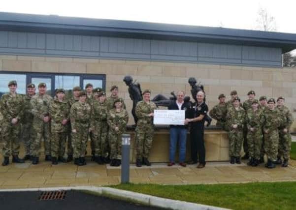 Detachment Commander Lt Sarah McCarthy and adult instructors and cadets from the B Company Worksop Detachment of Notts Army Cadet Force present a cheque to Phoenix House Recovery Centre in Catterick