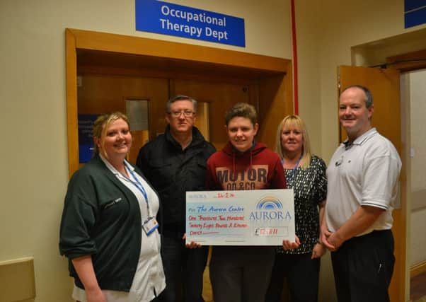 Bethany Snow (left, senior occupational therapist at Doncaster Royal Infirmary, left) and Brian Gilmore (right, senior phsiotheapist at Park Hill Hospital ) recevie the cheque from David Hubbard, Bradley Hubbard and Sue Milne