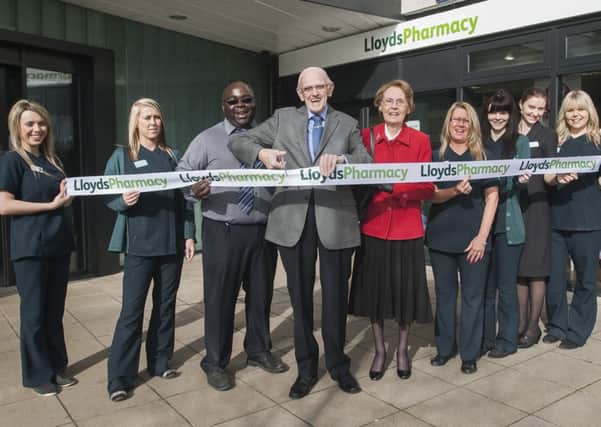 Brian and Valerie Wheatcroft cut the ribbon to open the new LLoydsPharmacy at Aston