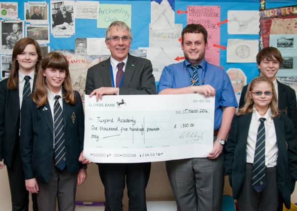 Tuxford Academy principal Geoff Lloyd, tutor Matt Hollingworth and students with their funding cheque